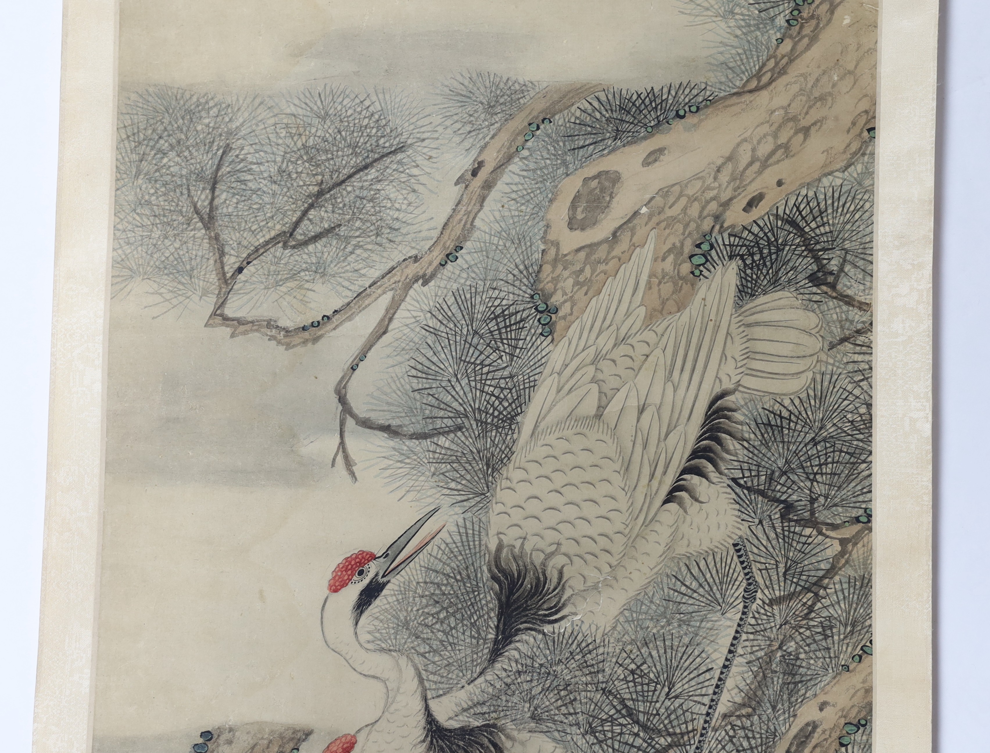 A Chinese scroll painting on paper of cranes perched in a pine tree, 19th century, image 163.5cm x 44cm